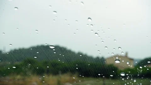 Close-up of rain drops on car glass. POV view through window with rain droplets Stock Footage 117123767