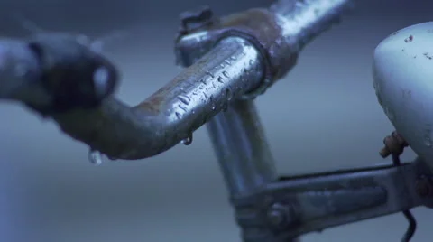 Close Up Of Rain Drops Falling On Bicycle Stock Footage 51148897