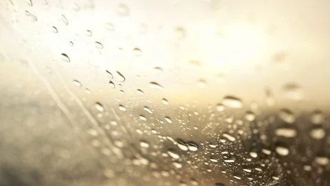 Close-up of Rain drops falling on the car windshield .Windshield wiper in action Stock Footage 77731200
