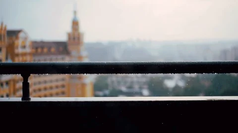 Close up of rain drops falling on the inox fence pouring rain day drop fence Stock Footage 99670569