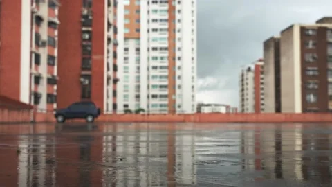 Close-up of rain drops on the foreground on pavement of city parking. Copy space Stock Footage 237768590