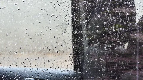 Close-up rain drops on glass surface Stock Footage 249476169