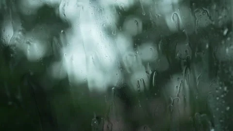 Close Up Rain Drops on Window with Blurred Green Trees Stock Footage 340806614
