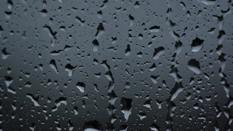 Close up rain drops on window glass in storm looking like teardrops on face Stock Footage 104502520