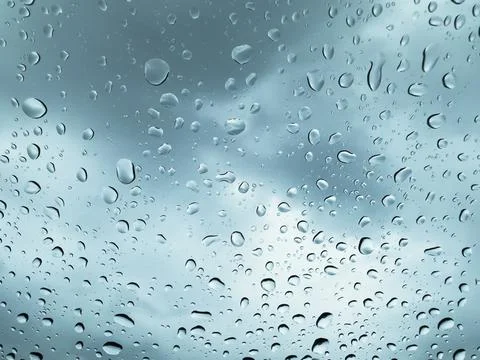 Close-up of rain drops on window glass Illustrazione stock