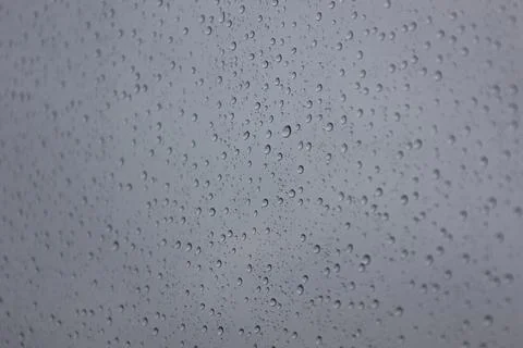 Close up of rain drops on window glass in bad weather Stock Photos