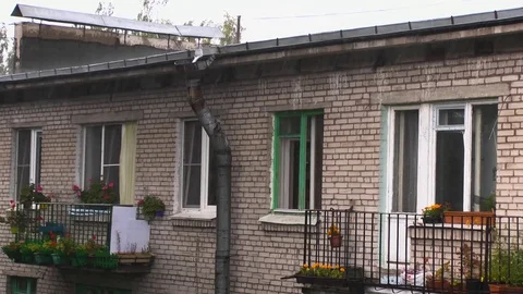Close-up of rain falling on and rolling off a roof and gutter on a house. Stock Footage 84173979