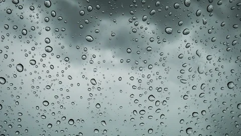 Close-up rain falls on the glass in front of the car, Water drop on glass. Stock Footage 111507279