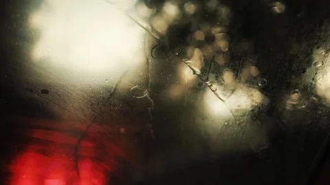 Close up rain flows and wipers on the front windshield glass window of car on Stock Footage 94531241