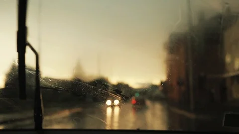 Close up rain flows and wipers on the front windshield glass window of car on Stock Footage 94531753