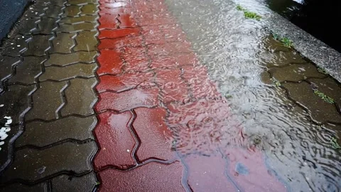 Close-up of Rain Pouring Down on Puddle-Soaked Sidewalk, HD Stock Footage 202299130