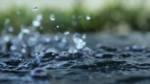 Close up rain water drop falling to the water surface in rainy season Stock Footage 112639874