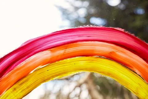 Close up of a rainbow being painted on a window. Stock Photos