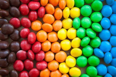 Close up of rainbow colored candy, sugar coated candies. Candy delicious swee Stock Photos