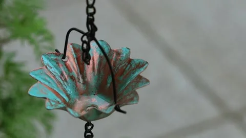 Close-Up of Raindrop Falling into Vintage Copper Rain Chain Cup Stock Footage 342319362