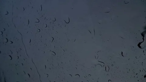 Close up raindrops on car window at dusk moody Stock Footage 343551949