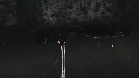 Close-up of raindrops cascading from an old metal roof during a heavy downpour Vídeo Stock 304965804