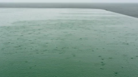 Close up of Raindrops Creating Ripples on Pool Surface Video stock 347984860