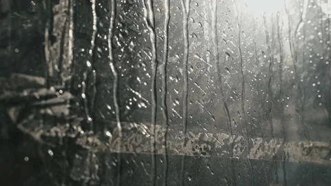 Close-up of raindrops dripping from the glass. Small raindrops run down the Stock Footage 213325569