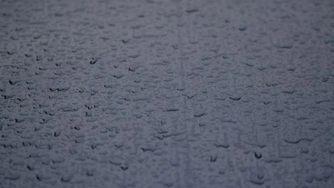 Close-up. Raindrops fall on the blue hood of the car. 59,94 fps Stock Footage 240182839