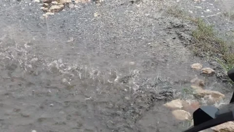 Close-Up of Raindrops Falling on Sand Stock Footage 322089911