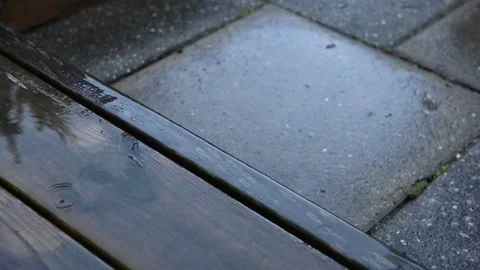 Close-Up of Raindrops Falling on a Wet Terrace Stock Footage 343269789
