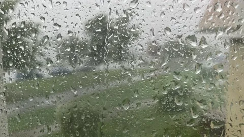Close-up raindrops flow down the glass.  rain and hurricane outside Stock Footage 221196906