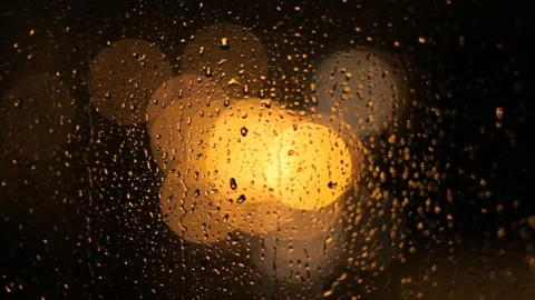 Close-up: Raindrops flow down the window. Rainy jazz. Video stock 100385201
