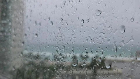 Close up raindrops on glass with soft focus background rainy day texture Stock Footage 331347324