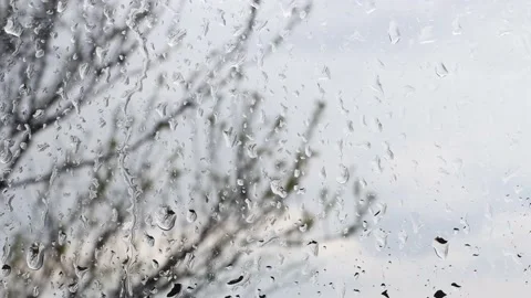 Close-up of raindrops running down the glass, viewed from inside the room. Stock Footage 192825797
