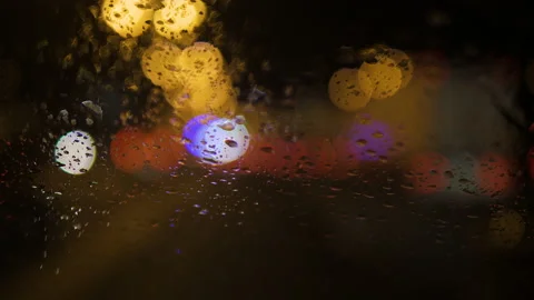 Close-up of raindrops running down the windshield of a car 스톡 동영상 169388975