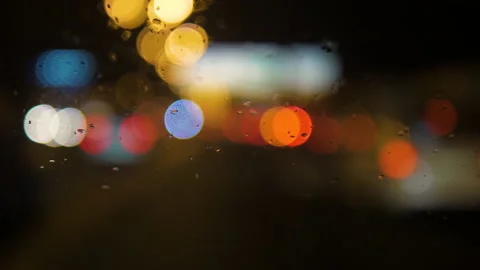 Close-up of raindrops running down the windshield of a car 스톡 동영상 169390531