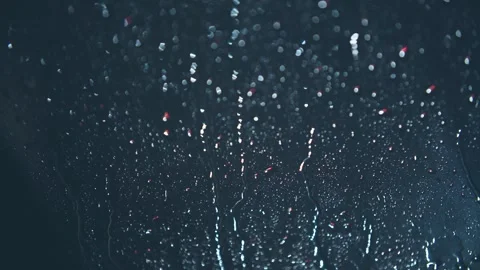 Close-up of raindrops sliding down on the glass at night. Stock Footage 295858566