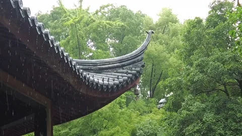 Close-up of raindrops sliding down the roof tiles of an ancient building. 스톡 동영상 335921212