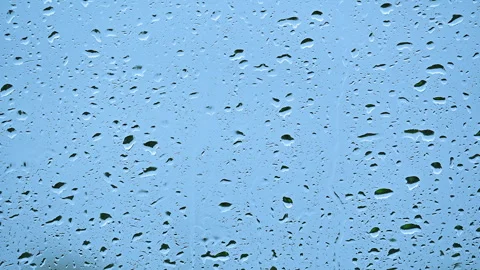 Close up raindrops sliding down window glass Stock Footage 260851069