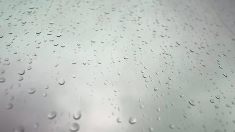 Close up of Raindrops on Window Glass and blurred Overcast sky Background Stockbeeldmateriaal 339286038