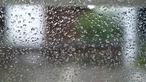 Close up of raindrops on the window glass with blurred urban city background. Stock Footage 148537516
