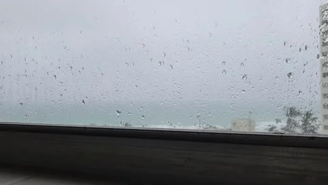 Close up raindrops on window with shallow depth of field abstract rainy texture Stock Footage 331347334