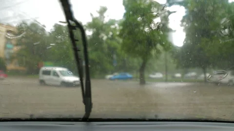 Close-up of raindrops on the windshield of the car. Windshield wipers are turned Stock-Footage 51769498
