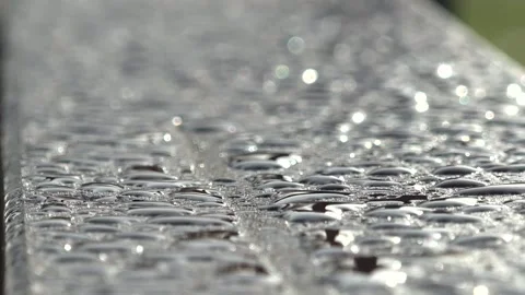 Close-up of raindrops on a wooden bench Stock Footage 221167957