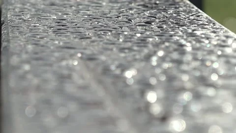 Close-up of raindrops on a wooden bench Stock Footage 221167959
