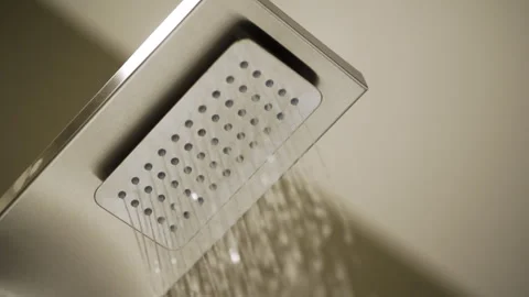 Close-Up of Rainfall Shower Head with Fine Water Jets - Slow Pan Left - UHD 4K Stock Footage 344082910