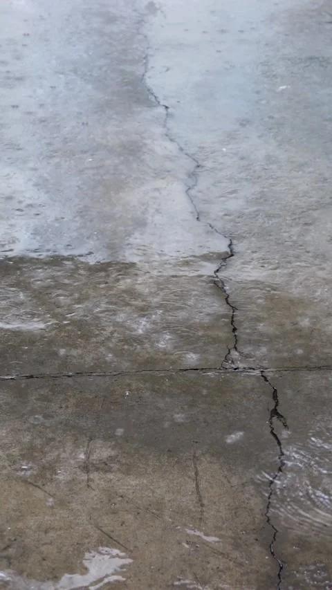 Close up of raining water drop on the cement ground with cracks Stock Footage 315213133