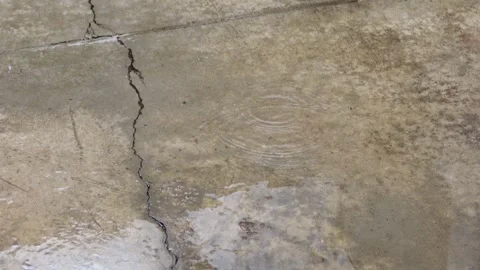 Close up of raining water drop on the cement ground with cracks Stock Footage 315213143