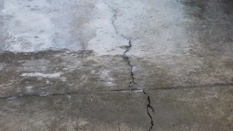 Close up of raining water drop on the cement ground with cracks Stock Footage 315213149