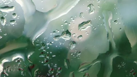 Close-up rainy day, water drop falling on glass of window Stock Footage 110730190