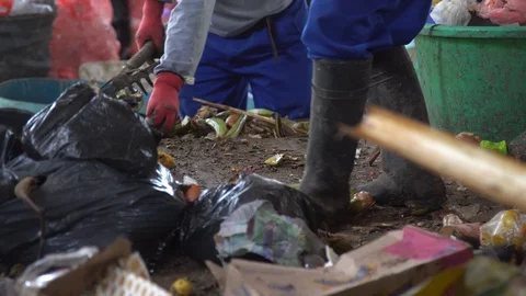 Close-up. rake the garbage. organics and plastic. waste treatment. legs in boots Stock Footage 127369285