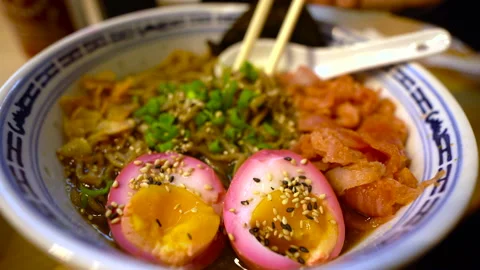 Close up of  Ramen noodles picked out with chopsticks. Traditional Japanese soup Stock Footage 138319062