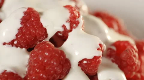 Close-up of raspberries with cream. Loopable. Stock Footage 39984997