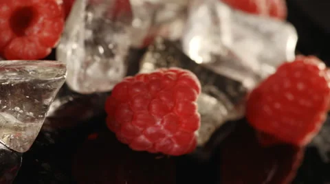 Close-up of raspberries with ice on black background. Loopable Stock Footage 40000913